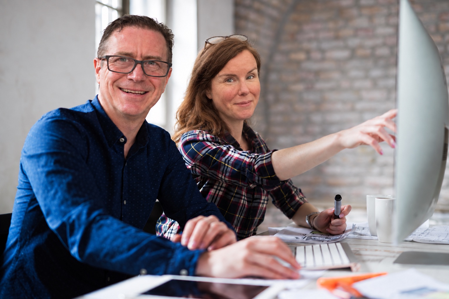 Perry Gordon and a woman seated together at a desktop computer.